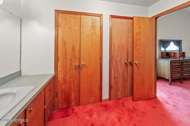 bathroom with a textured ceiling and vanity