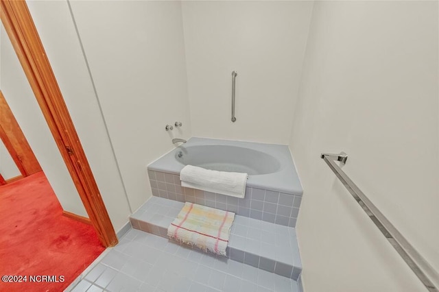 bathroom featuring tile patterned flooring and a bath