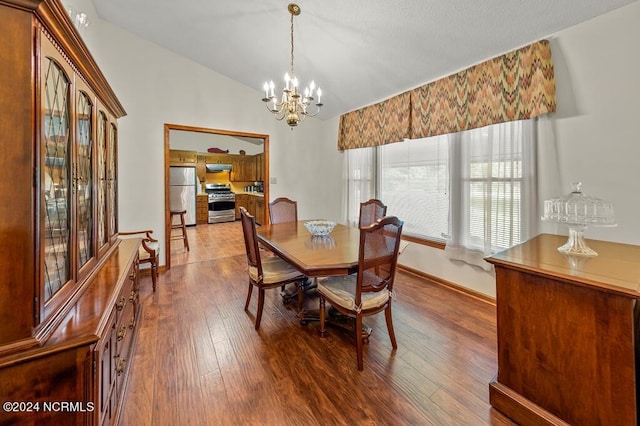 dining room featuring an inviting chandelier, baseboards, vaulted ceiling, and dark wood-style flooring