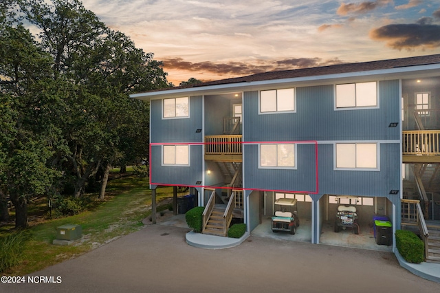 view of front of house featuring a balcony and stairs