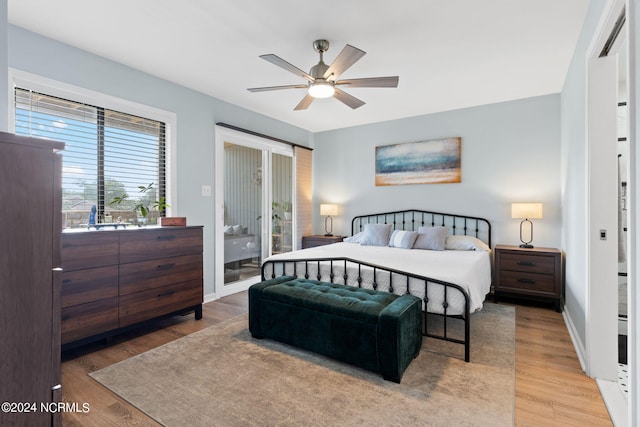 bedroom with baseboards, wood finished floors, a ceiling fan, and access to exterior