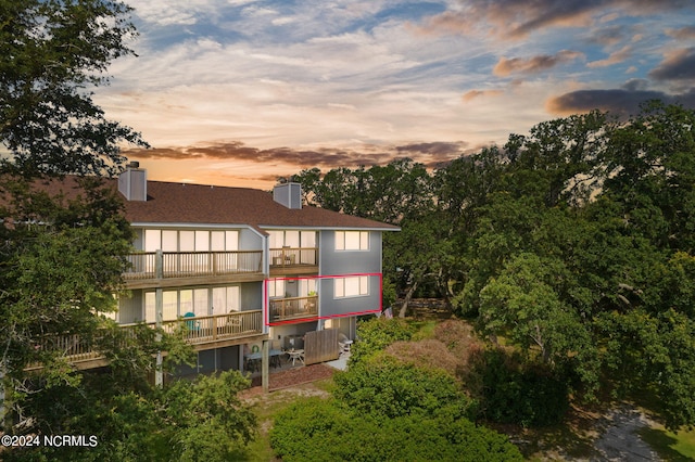 back of property featuring a balcony