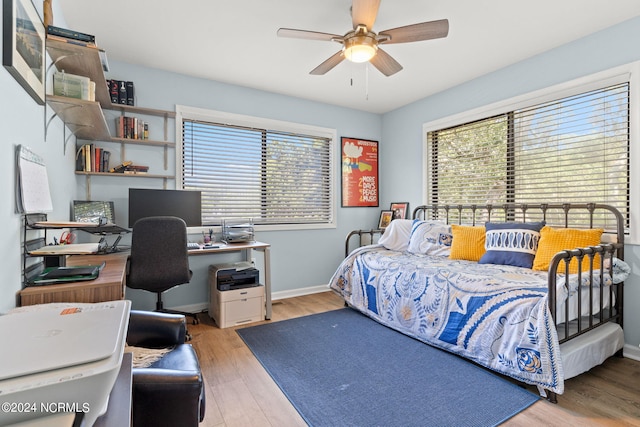 bedroom with light hardwood / wood-style floors and ceiling fan