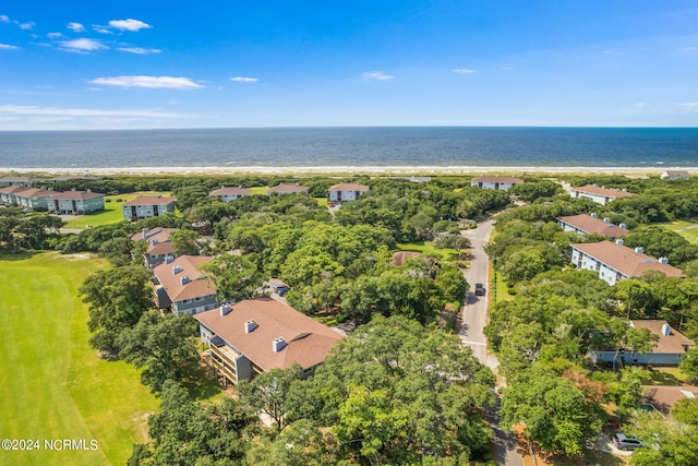 drone / aerial view featuring a beach view and a water view