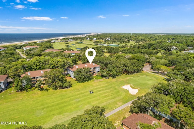 drone / aerial view with golf course view and a water view