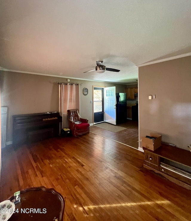 unfurnished living room featuring ornamental molding, dark hardwood / wood-style floors, and ceiling fan