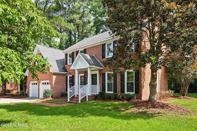 view of front of property featuring a garage and a front yard