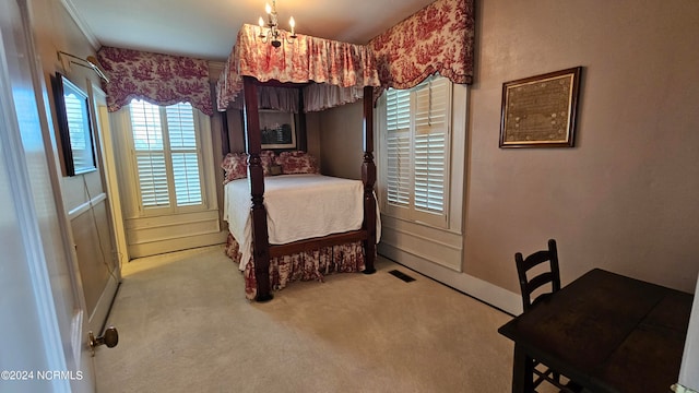 bedroom featuring a notable chandelier and light carpet