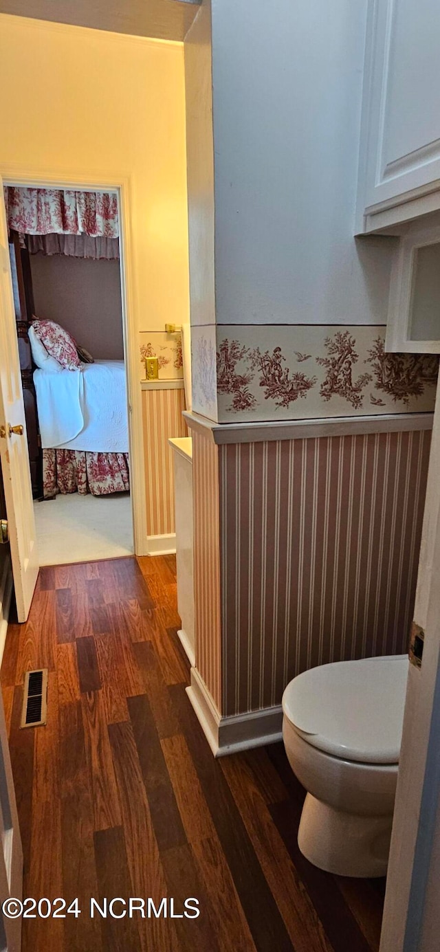 bathroom featuring toilet and hardwood / wood-style flooring