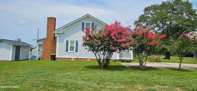 view of property exterior with a yard