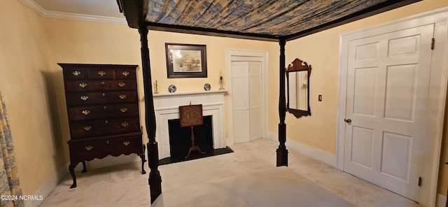 carpeted bedroom featuring ornamental molding and a brick fireplace