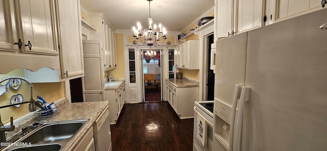 kitchen with pendant lighting, dark wood-type flooring, a notable chandelier, white appliances, and light stone countertops