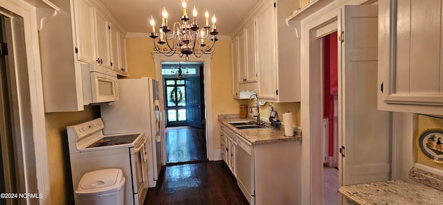 kitchen with washer / clothes dryer, white cabinetry, ornamental molding, dark hardwood / wood-style floors, and sink