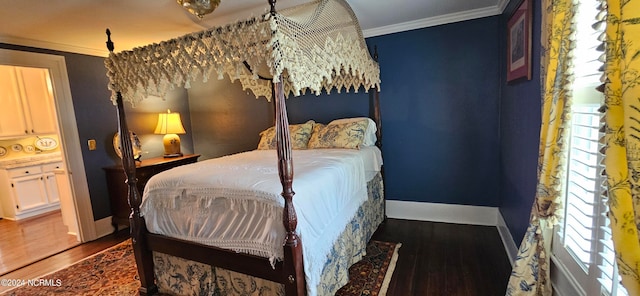 bedroom featuring ornamental molding and dark hardwood / wood-style flooring