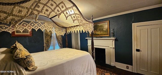 bedroom with crown molding and dark hardwood / wood-style flooring