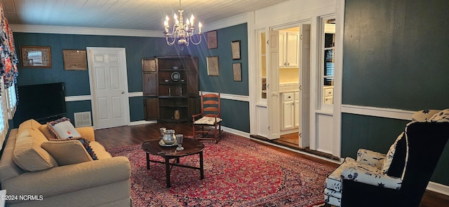 living room featuring ornamental molding, a notable chandelier, dark wood-type flooring, and wooden ceiling