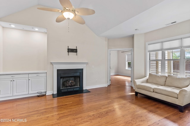 unfurnished living room featuring light hardwood / wood-style flooring, high vaulted ceiling, and ceiling fan