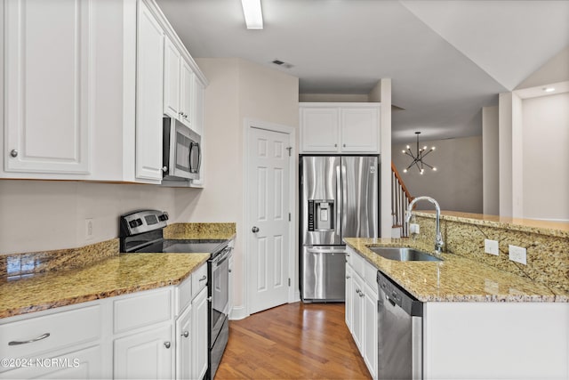 kitchen featuring a notable chandelier, stainless steel appliances, sink, and white cabinets