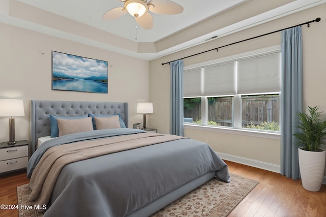 bedroom with ceiling fan and hardwood / wood-style floors