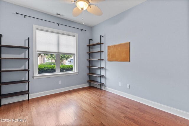 spare room with ceiling fan and light wood-type flooring