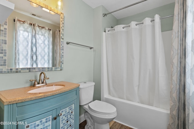 full bathroom featuring vanity, shower / tub combo with curtain, hardwood / wood-style flooring, and toilet