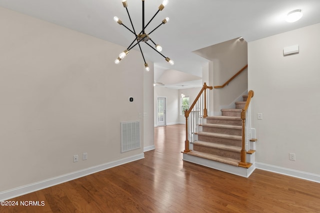 interior space with a notable chandelier and hardwood / wood-style floors