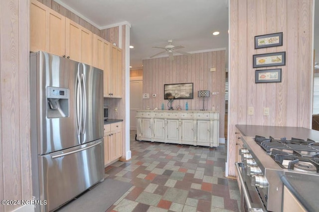 kitchen with stainless steel appliances, light brown cabinets, dark tile patterned flooring, crown molding, and ceiling fan