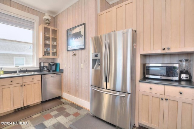 kitchen featuring dark tile patterned flooring, light brown cabinets, and stainless steel appliances