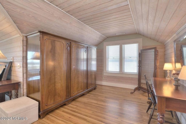 interior space featuring wood walls, light wood-type flooring, vaulted ceiling, and wooden ceiling