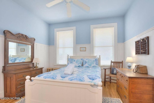 bedroom with light hardwood / wood-style floors, multiple windows, and ceiling fan