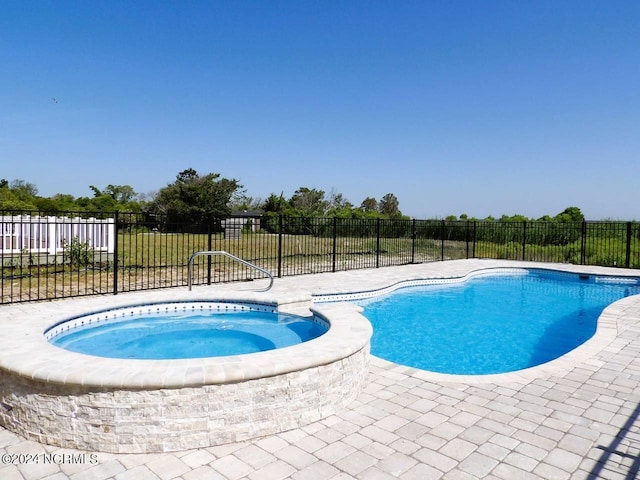 view of pool featuring an in ground hot tub