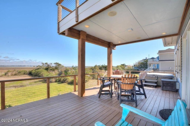 wooden deck featuring a lawn