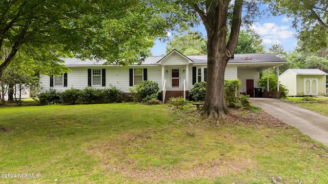 ranch-style house with a storage shed and a front lawn