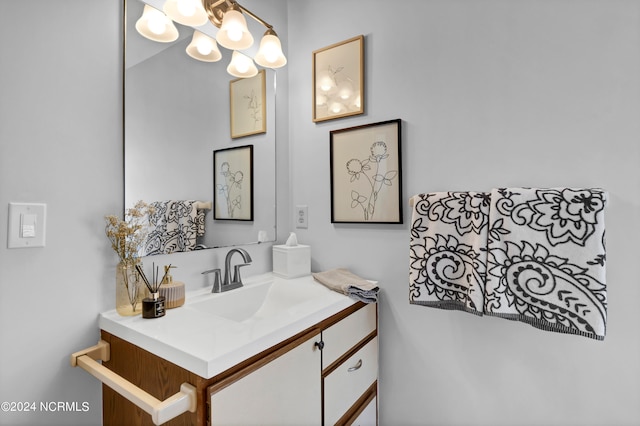 bathroom with vanity and an inviting chandelier