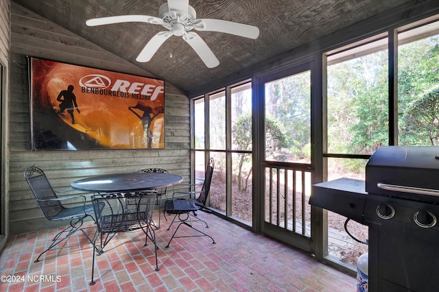 sunroom / solarium featuring ceiling fan, lofted ceiling, and a wealth of natural light