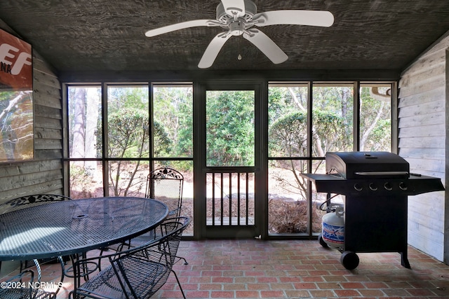 sunroom / solarium with a wealth of natural light, vaulted ceiling, and ceiling fan