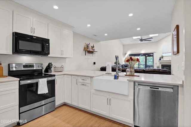 kitchen featuring light hardwood / wood-style floors, sink, white cabinetry, appliances with stainless steel finishes, and ceiling fan