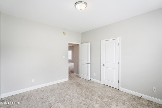 unfurnished bedroom with light carpet