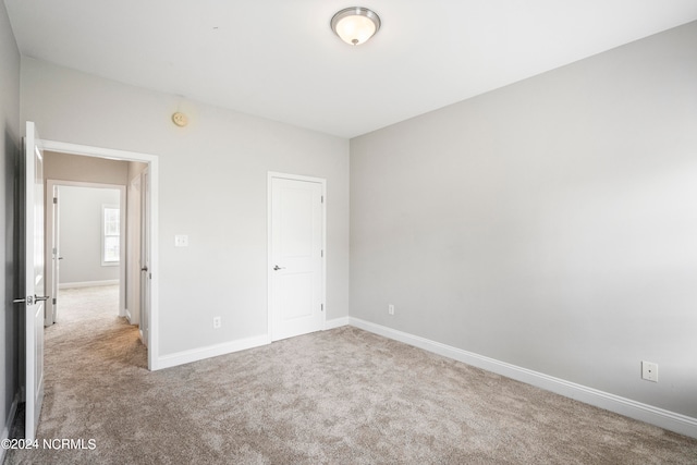 unfurnished bedroom with light carpet