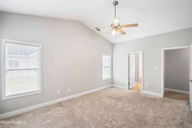 unfurnished bedroom with ceiling fan, vaulted ceiling, and light colored carpet