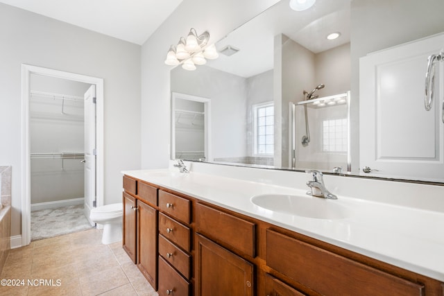 bathroom with tile patterned flooring, dual vanity, and toilet