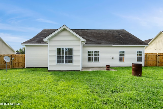 back of property with a patio and a lawn