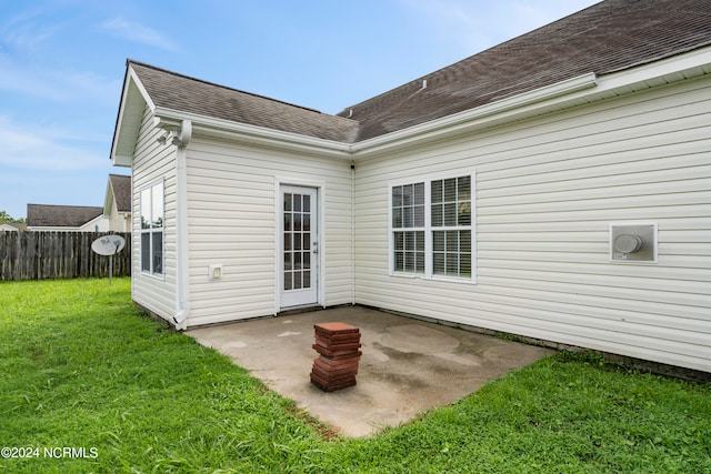 back of property with a patio and a yard