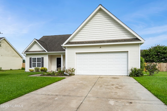 view of front of property featuring a garage and a front lawn