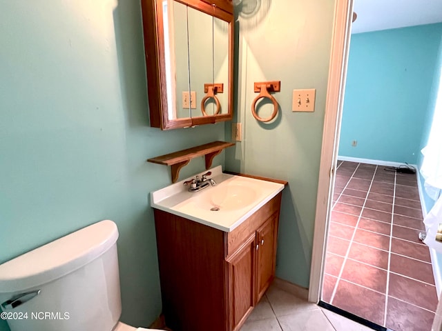 bathroom with vanity, tile patterned flooring, and toilet