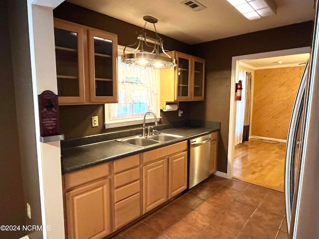 kitchen featuring stainless steel appliances, sink, dark hardwood / wood-style flooring, pendant lighting, and a notable chandelier