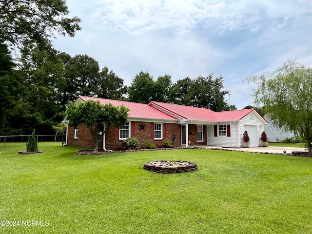 single story home featuring a garage and a front yard