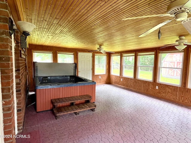 unfurnished sunroom featuring plenty of natural light and wooden ceiling