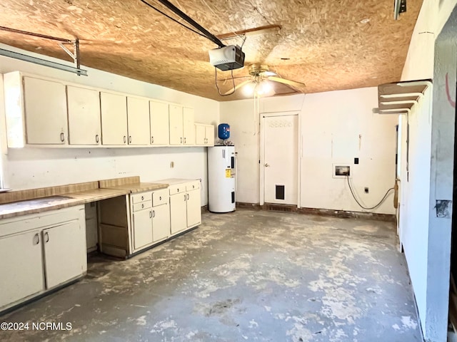 garage featuring a garage door opener, water heater, and ceiling fan