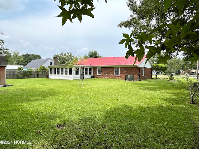 back of property featuring a lawn